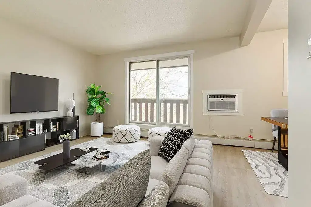 Living room with large windows and natural light at Hyland Manor in Bonnyville.