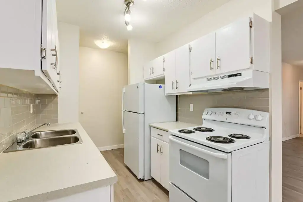 Galley style kitchen with appliances at Hyland Manor in Bonnyville.
