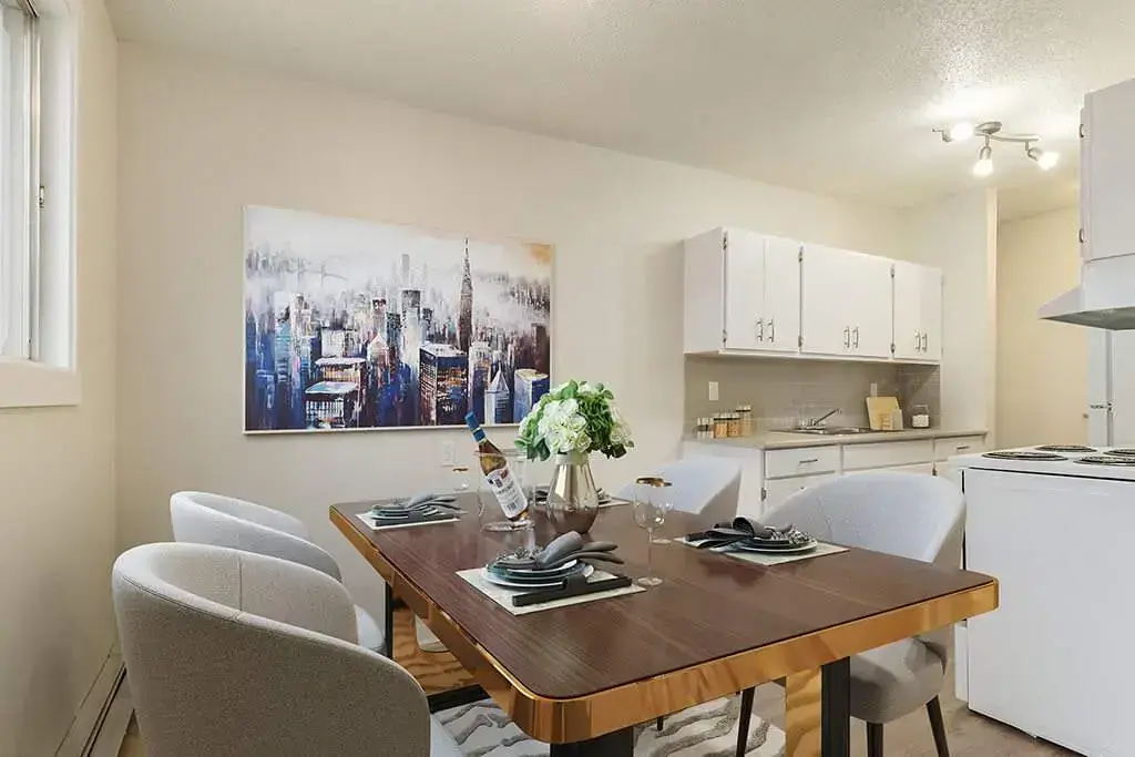 Galley style kitchen with natural light and dining area at Hyland Manor in Bonnyville.