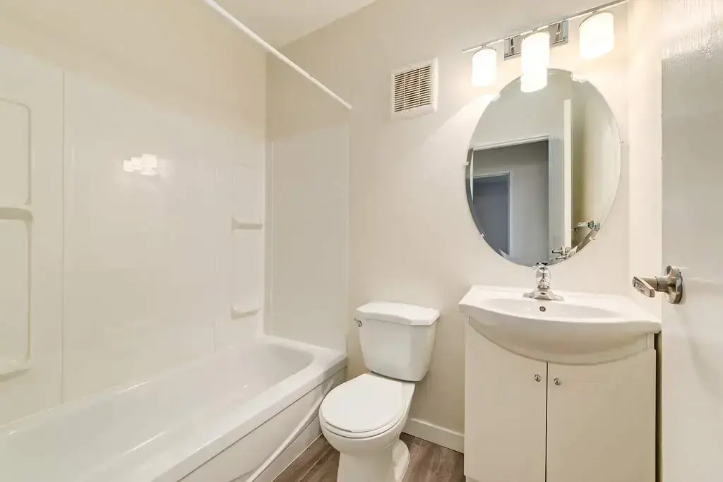 Apartment bathroom with tub and shower at Hyland Manor in Bonnyville.