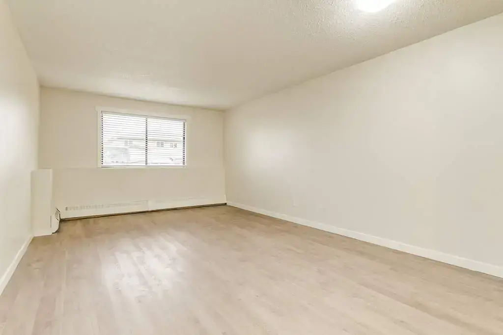 Living room with large windows and natural light at King Art in Bonnyville.