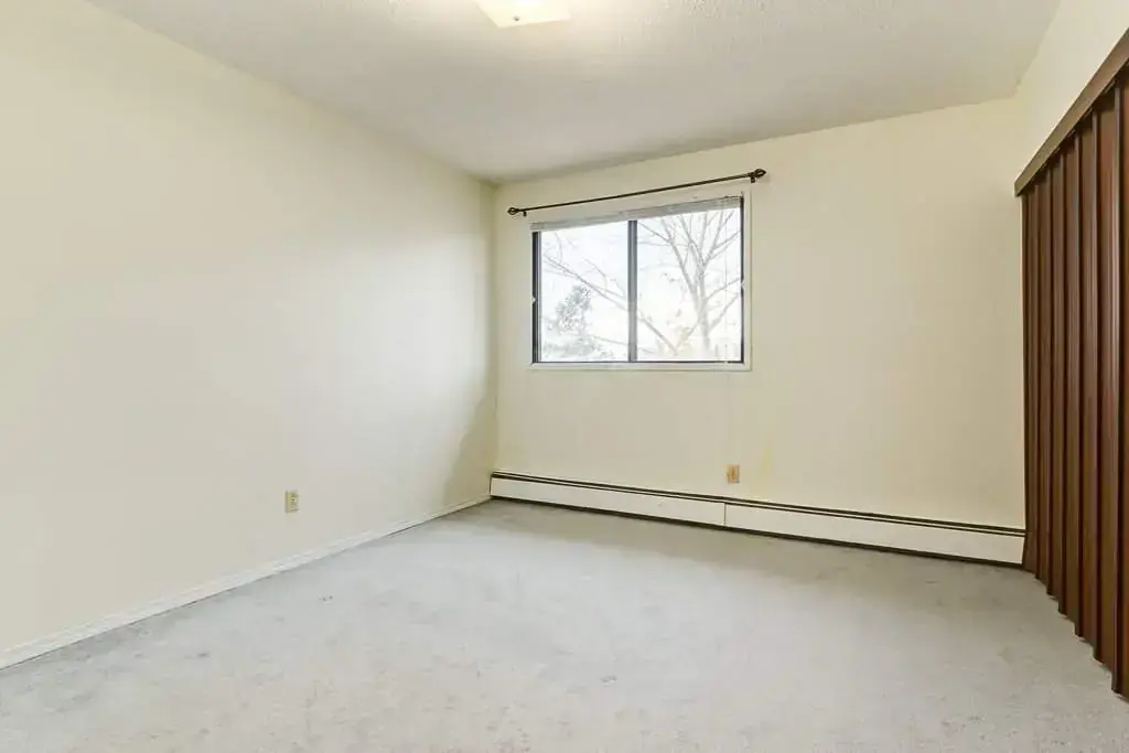 Open bedroom space with flexible layout at King Art in Bonnyville.