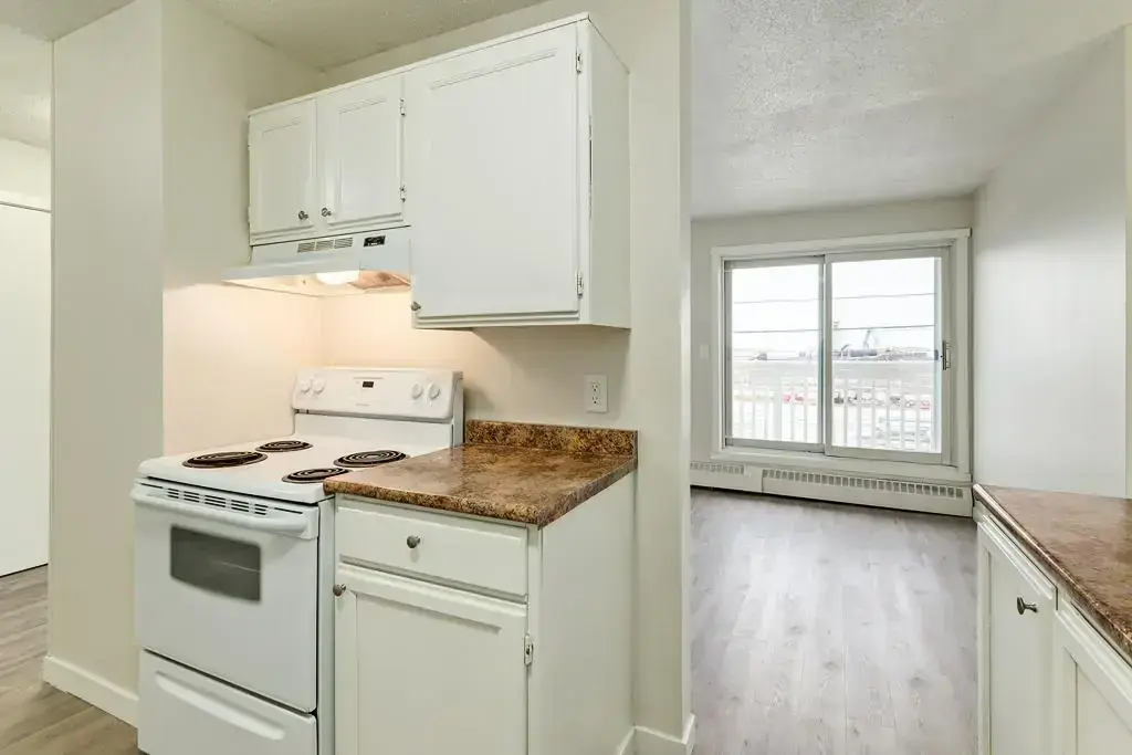 Galley style kitchen with appliances at Matichuk in Bonnyville.
