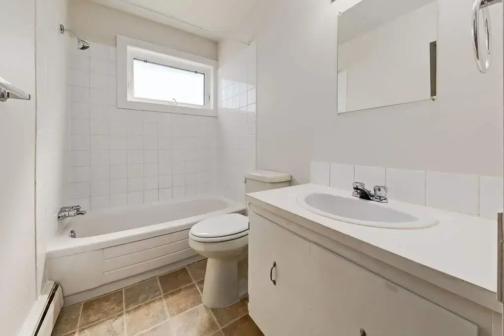Well-maintained bathroom with tub and shower at Lamplighter in Camrose.