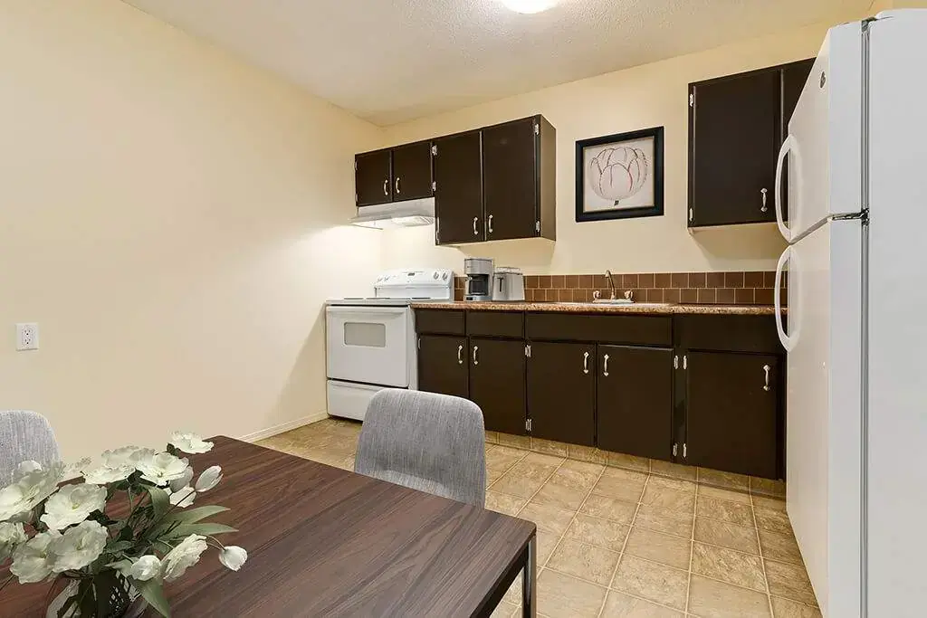 Well-appointed kitchen with dining area at Spruce View Apartments in Camrose.