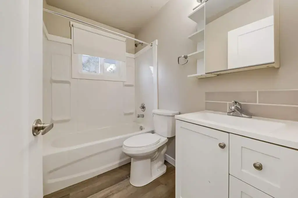 Full bathroom with tub and shower at Aiva Manor in Edmonton