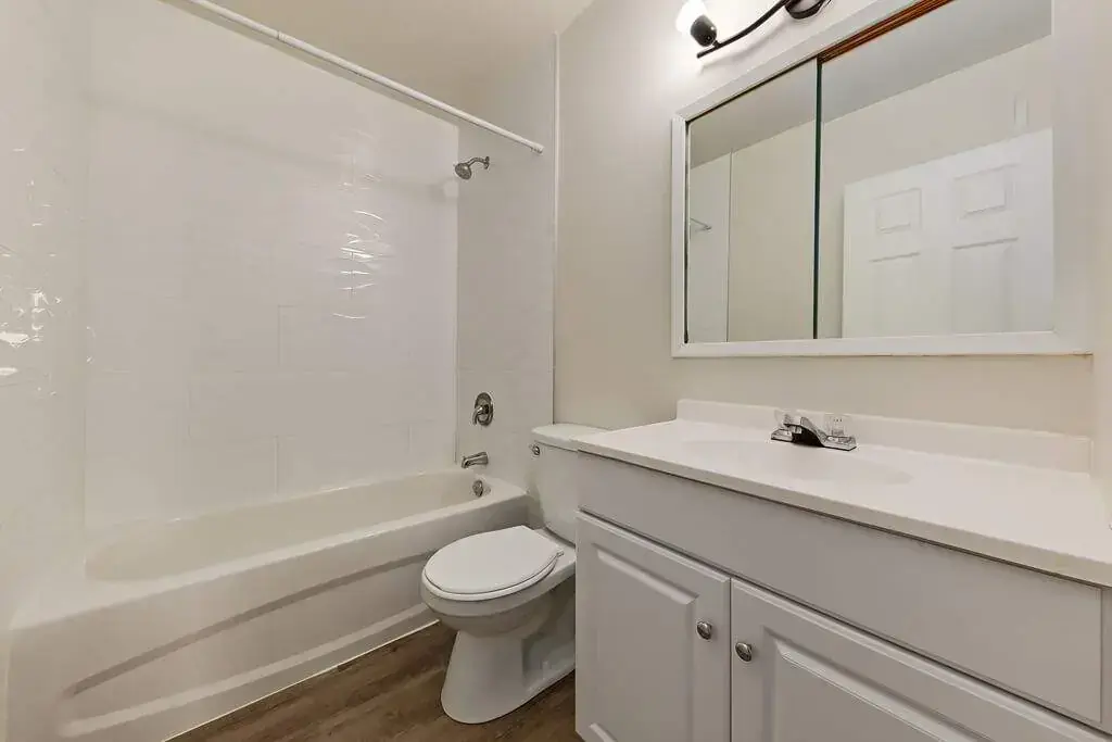 Full bathroom with tub and shower at Aiva Manor in Edmonton.
