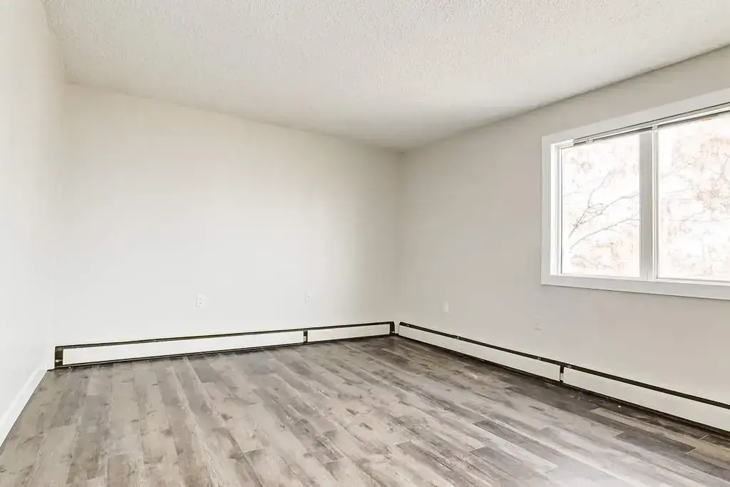 Open living room space at Cloverdale Apartments in Edmonton.