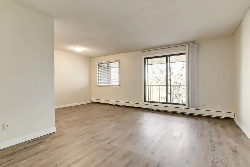 Living room with large windows and natural light at Hudson Court in Edmonton.
