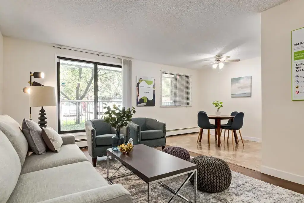Bright living room with large windows at Hudson Court in Edmonton.