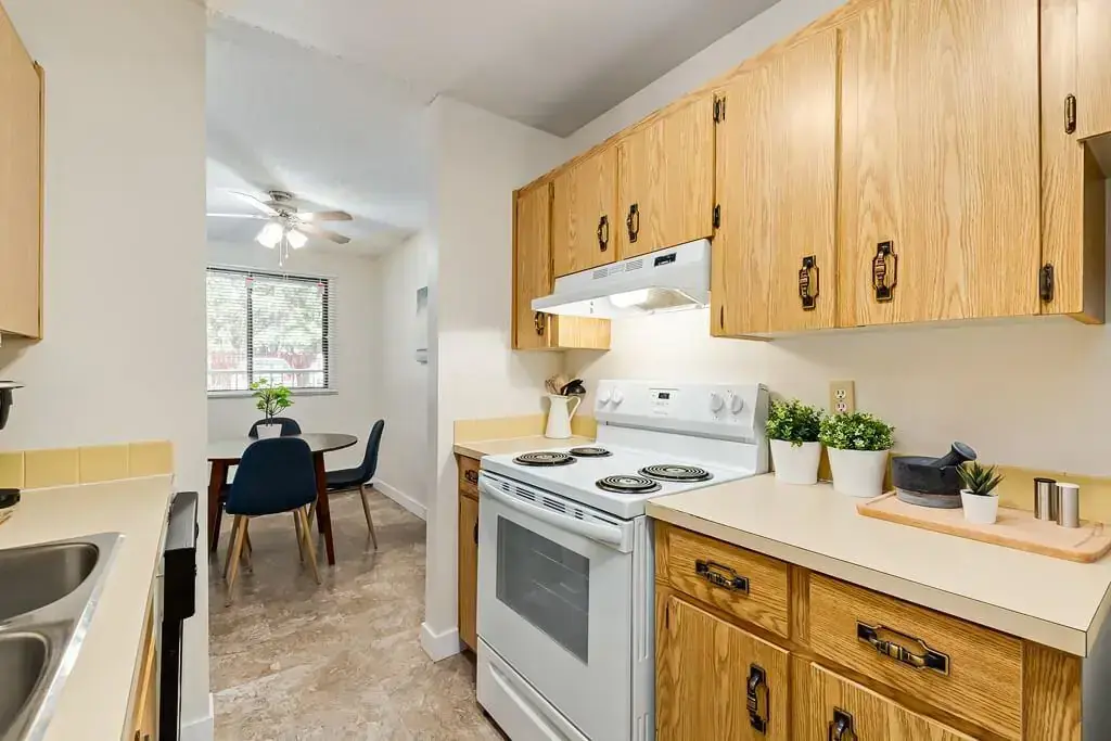 Galley style kitchen with appliances at Hudson Court in Edmonton.