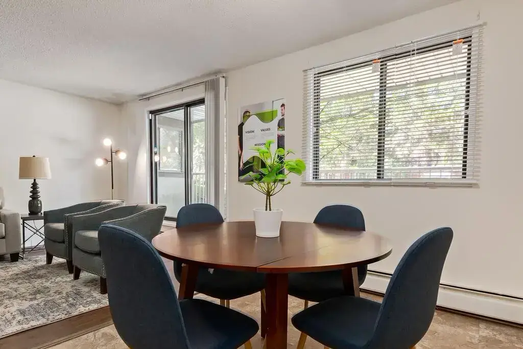 Sunlit dining area and living room at Hudson Court in Edmonton.