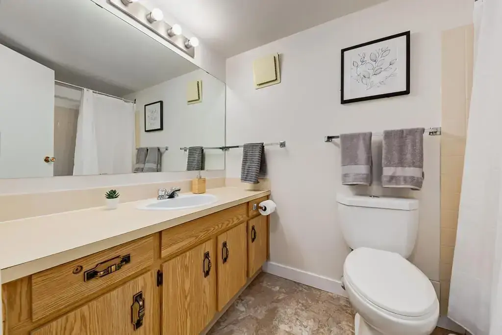 Comfortable full bathroom with tub and shower at Hudson Court in Edmonton.