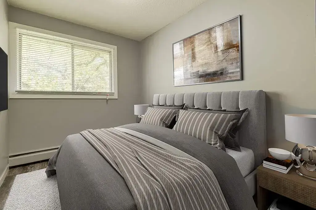Comfortable and well-sized bedroom at Lenita Manor in Edmonton.