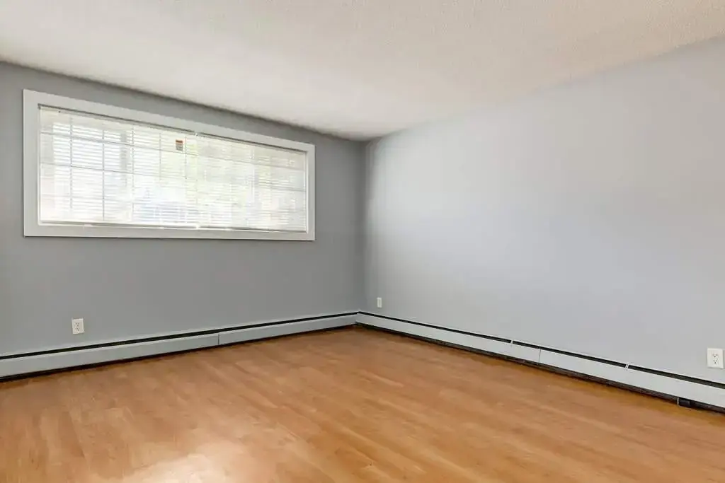 Bright bedroom with comfortable proportions at Lenita Manor in Edmonton.