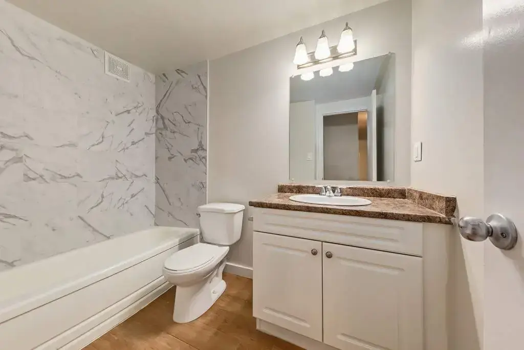 Comfortable full bathroom with tub and shower at Lenita Manor in Edmonton.