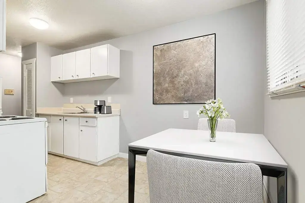 Dining area with natural light at Linda Manor in Edmonton.