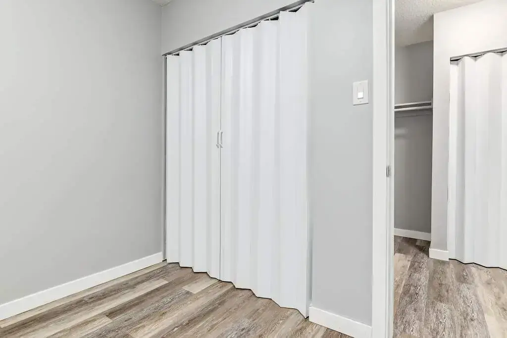 Open bedroom space with flexible layout at Linda Manor in Edmonton.