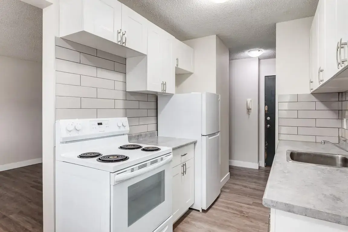 Galley style kitchen with appliances at Lockwood Apartments in Edmonton.