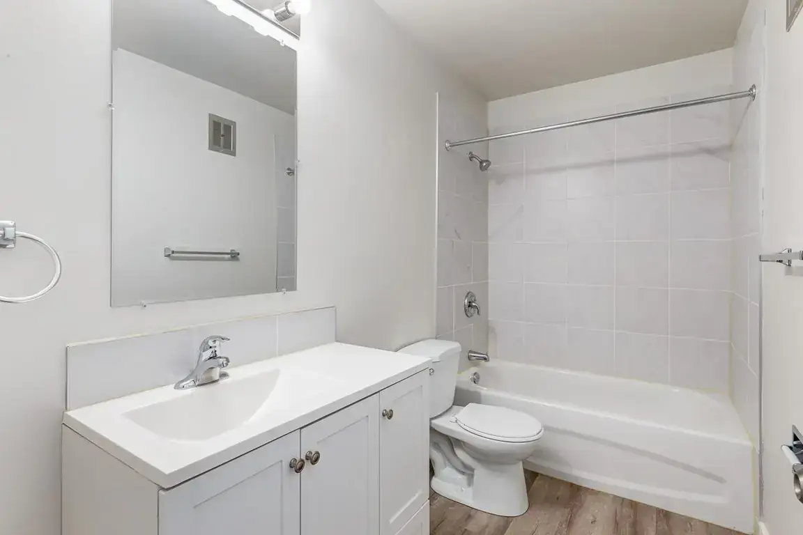 Clean full bathroom with tub and shower at Lockwood Apartments in Edmonton.