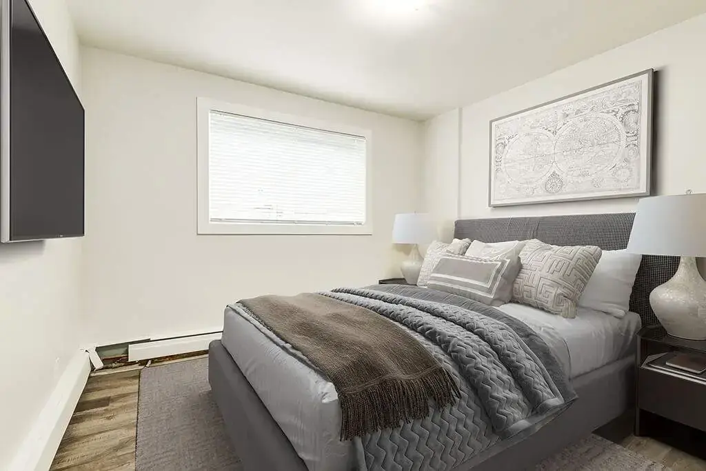 Open bedroom space with flexible layout at Phelips Apartments in Edmonton.
