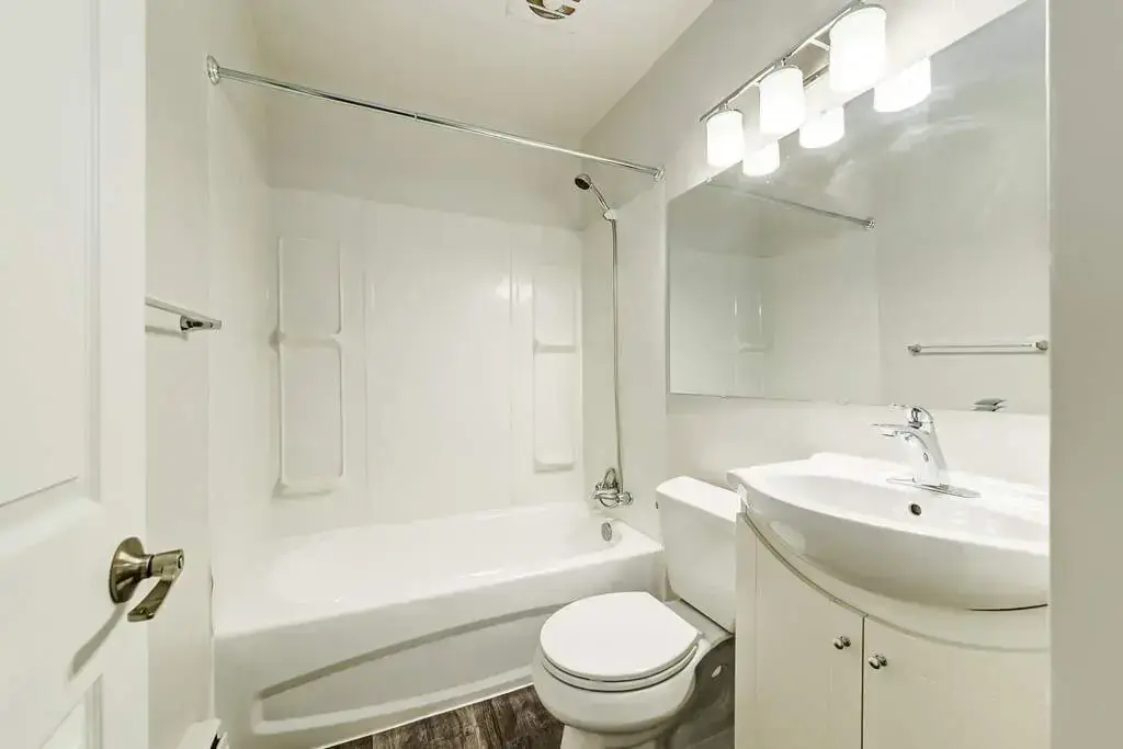 Comfortable full bathroom with tub and shower at Phelips Apartments in Edmonton.