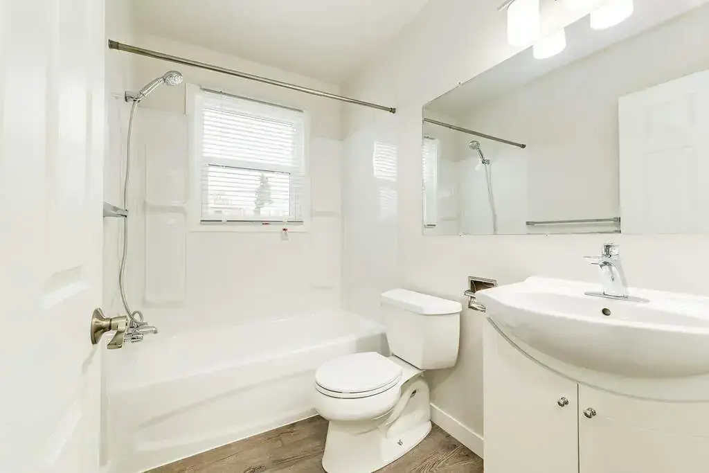 Comfortable full bathroom with tub and shower at Phelips Apartments in Edmonton.