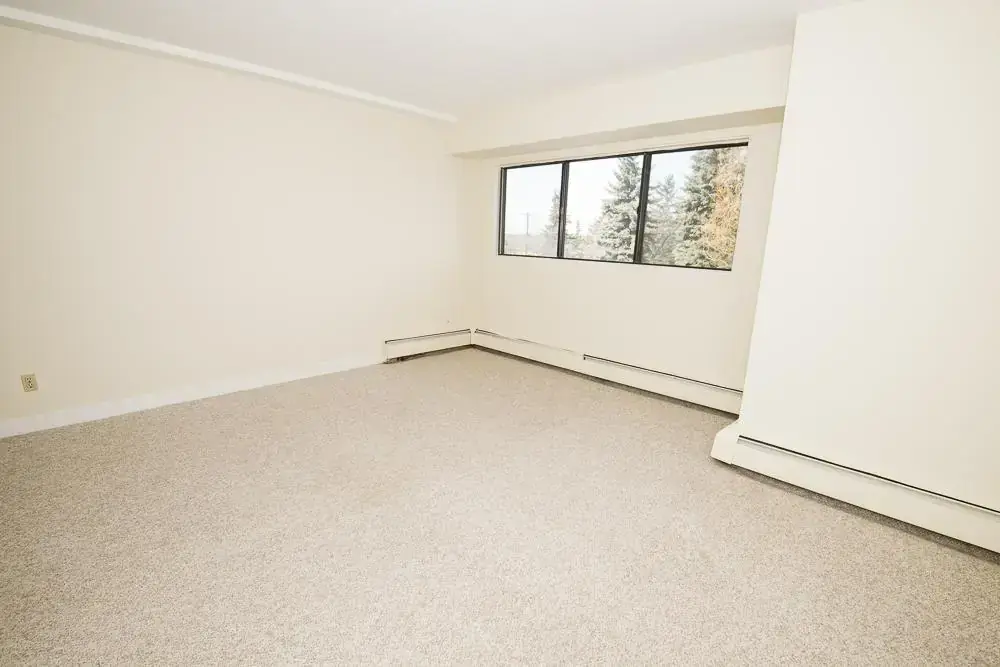 Bright bedroom with comfortable proportions at South Ridge Apartments in Edmonton.