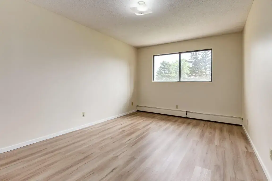 Bright bedroom with comfortable proportions at South Ridge Apartments in Edmonton.