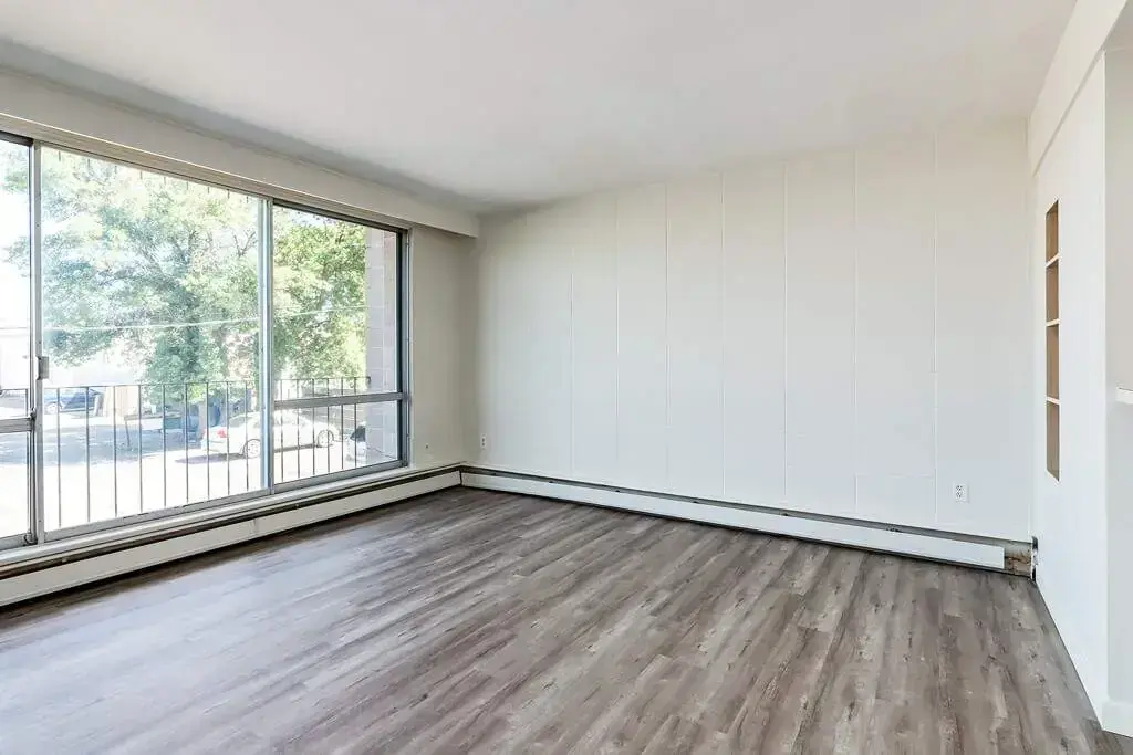 Bright living room with large windows at Applewood in Lethbridge.