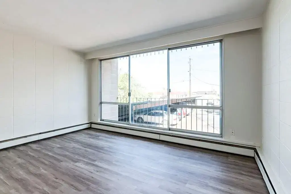 Living room with large windows and natural light at Applewood in Lethbridge.