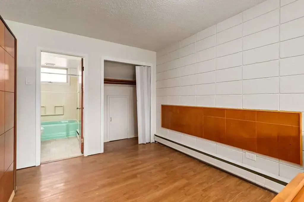 Bedroom with in-suite full bathroom at Bel-Aire Apartments in Lethbridge.