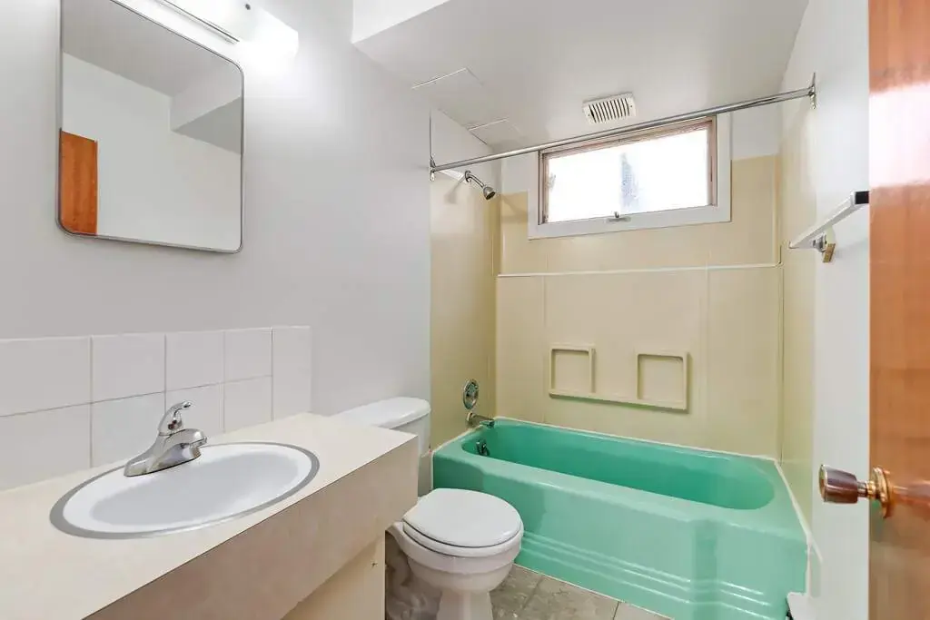 Comfortable full bathroom with tub and shower at Bel-Aire Apartments in Lethbridge.