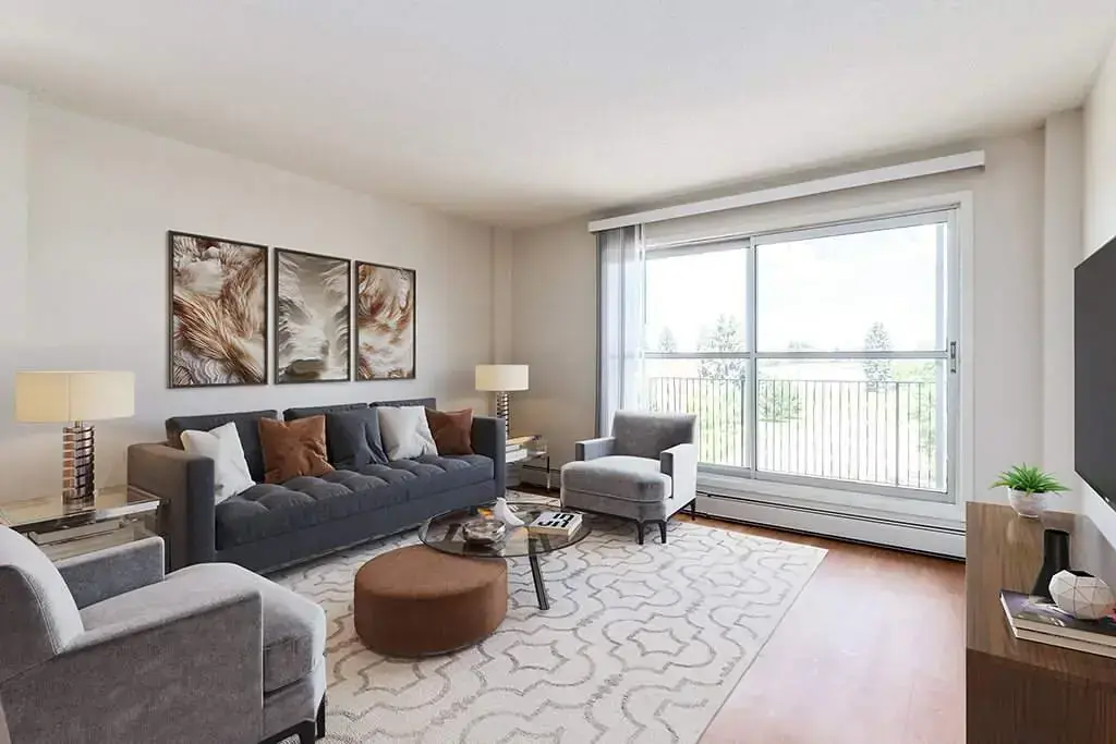 Bright and open living room with large windows at Evergreen Terrace in Lethbridge.
