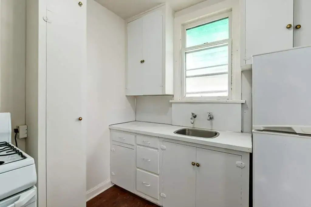 Well-maintained kitchen with natural light at Tudor Manor in Lethbridge.