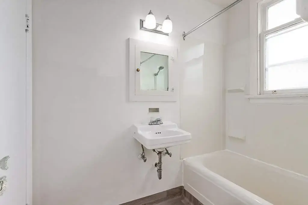 Apartment bathroom with tub and shower at Tudor Manor in Lethbridge.