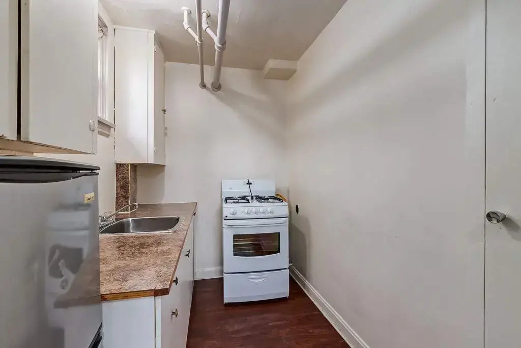 Well-appointed kitchen with appliances at Tudor Manor in Lethbridge.
