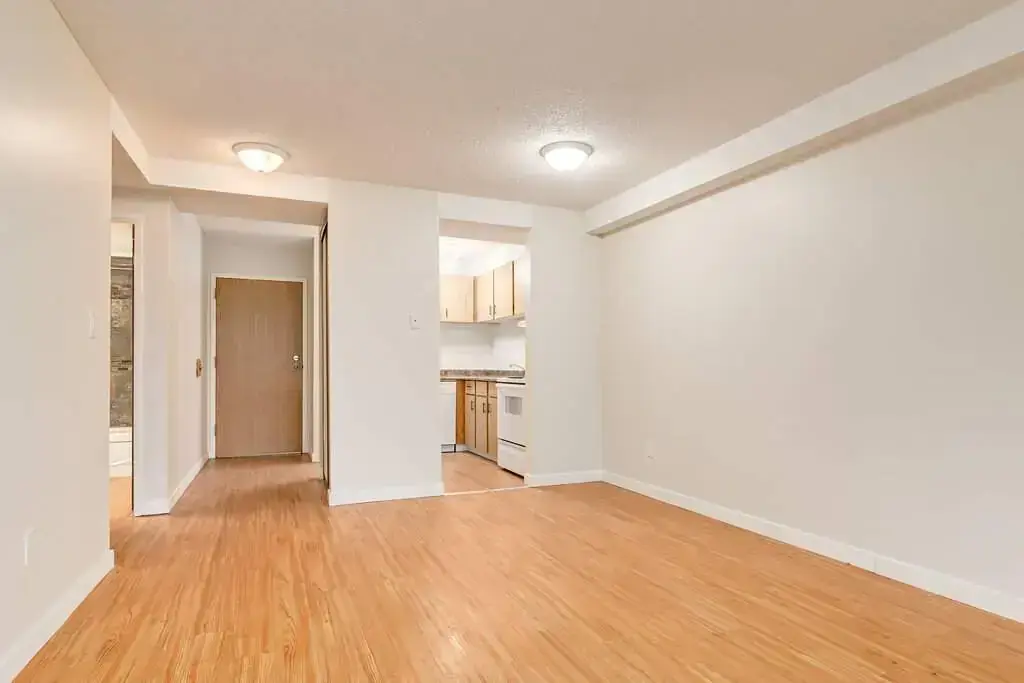 Open living room space with access to the kitchen at Cambridge Court in Lloydminster.