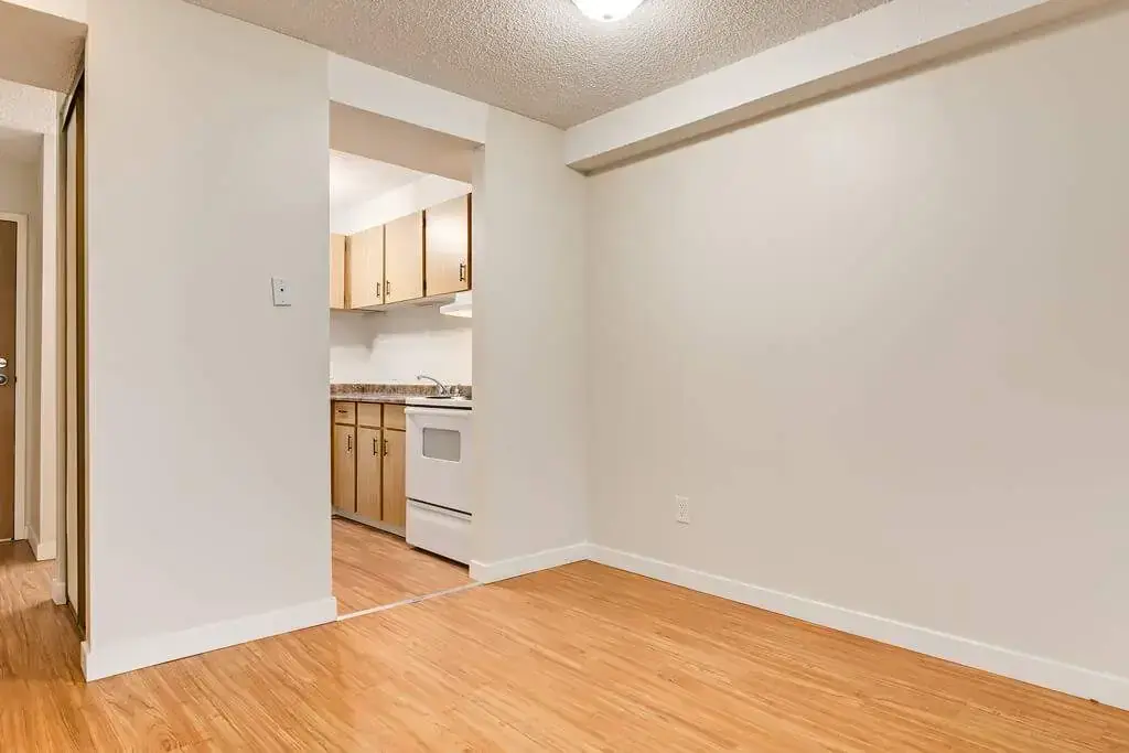 Galley style kitchen with access to the living room at Cambridge Court in Lloydminster.