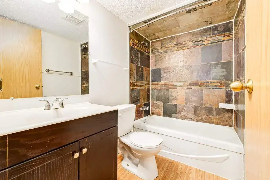 Well-maintained bathroom with tub and shower at Cambridge Court in Lloydminster.