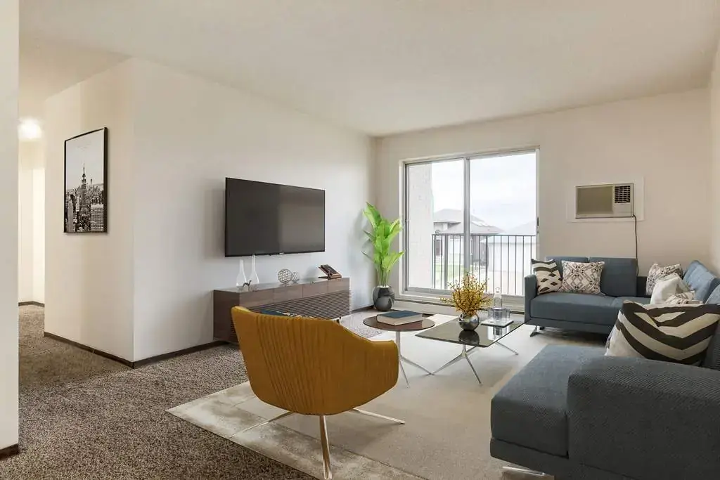 Living room with large windows and natural light at Hillview Apartments in Medicine Hat.