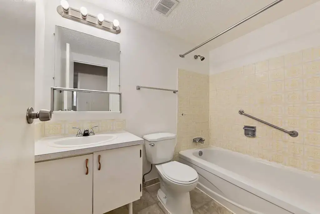 Apartment bathroom with tub and shower at Hillview Apartments in Medicine Hat.