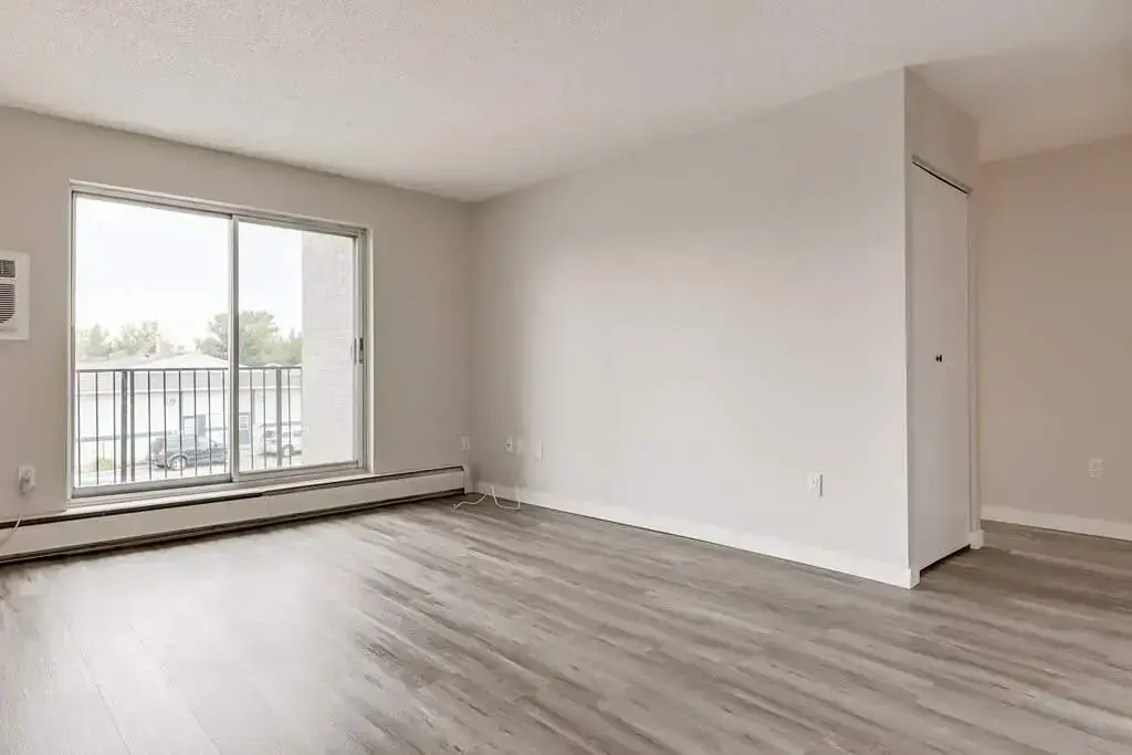 Bright living room with large windows at Hillview Apartments in Medicine Hat.