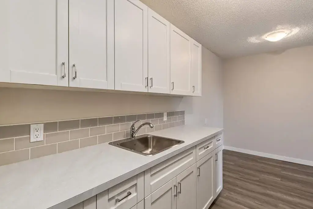 Contemporary kitchen with stainless steel appliances at Hillview Apartments in Medicine Hat.