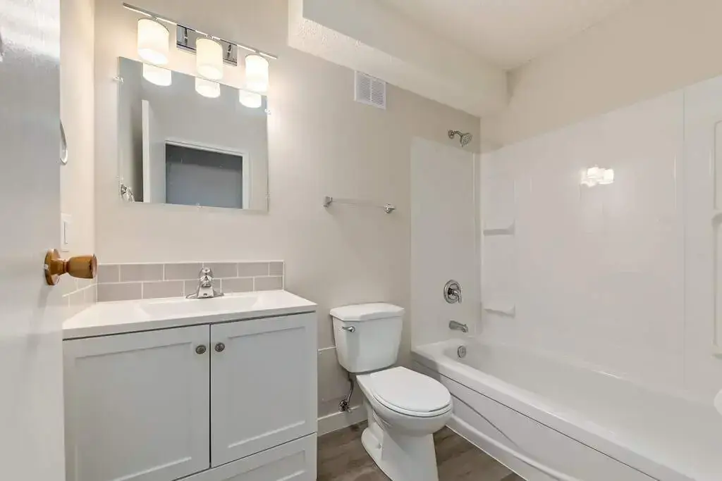 Comfortable full bathroom with tub and shower at Hillview Apartments in Medicine Hat.