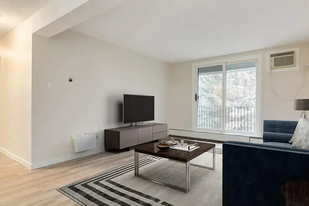 Living room with large windows and natural light at Forest Gardens in Moose Jaw.
