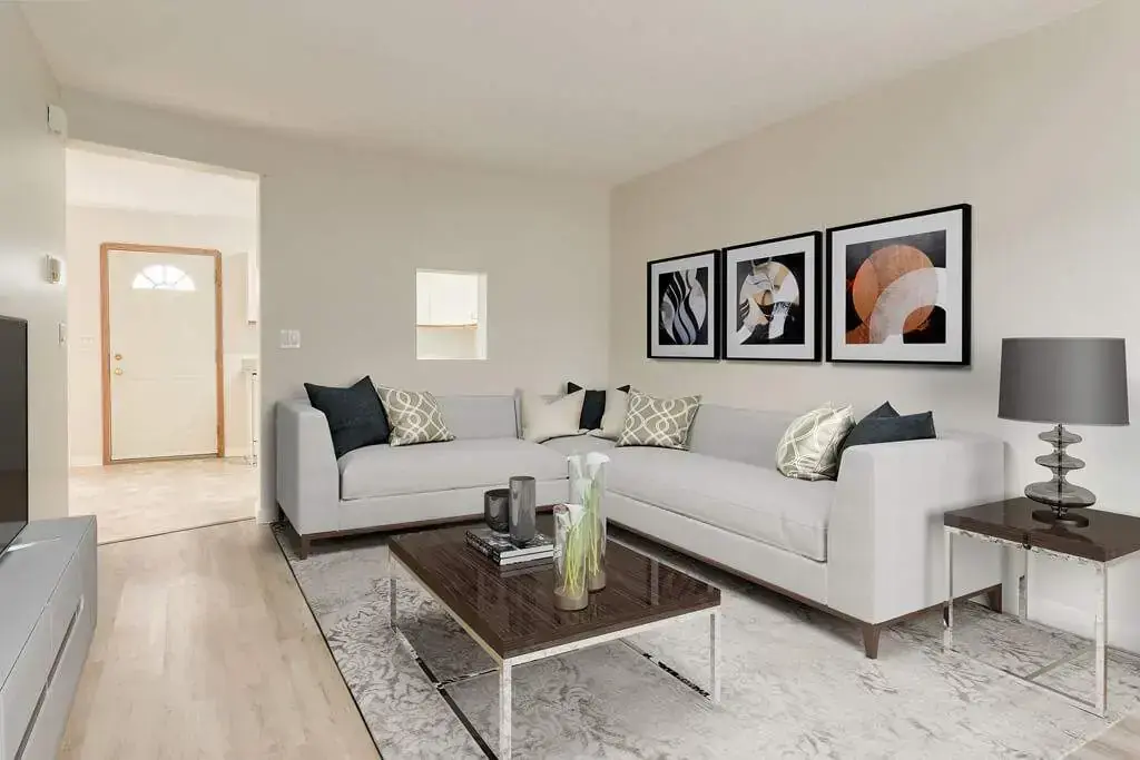 Bright living room with large windows at Kyte Crescent Townhomes in Red Deer.