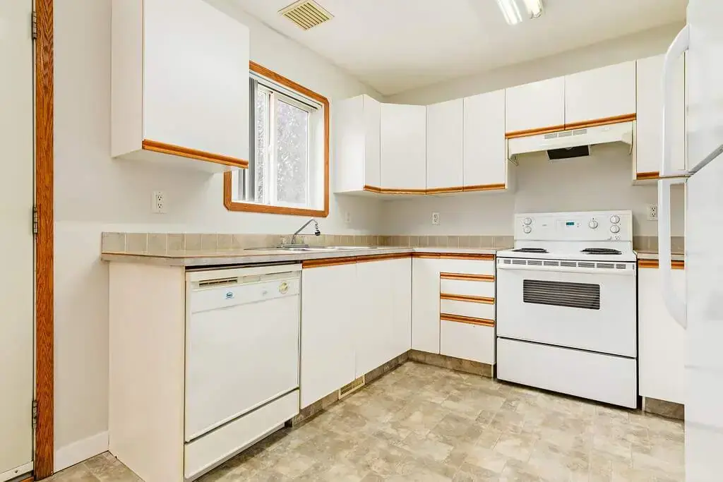 Open kitchen design connected to living space at Kyte Crescent Townhomes in Red Deer.