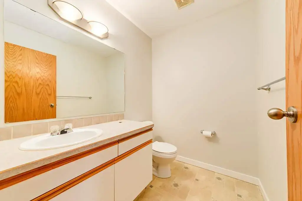Clean full bathroom with tub and shower at Kyte Crescent Townhomes in Red Deer.