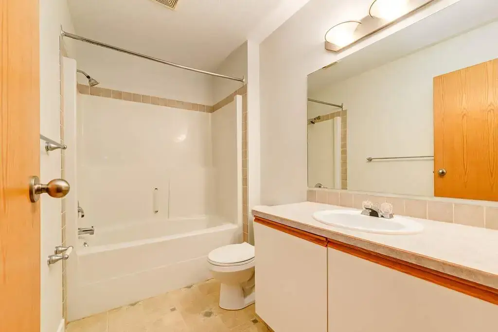 Apartment bathroom with tub and shower at Kyte Crescent Townhomes in Red Deer.
